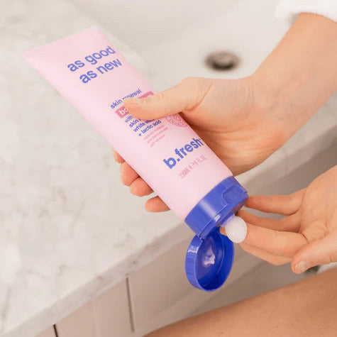 Model applying As Good As New skin renewal body serum from b.fresh, showcasing its moisturizing formula.