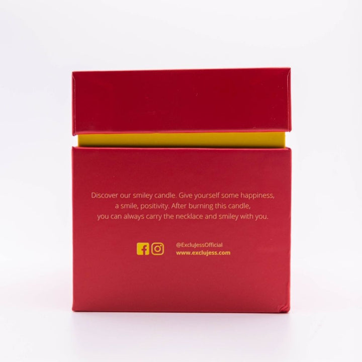 Smiley candle packaging with a cheerful message about happiness and positivity.