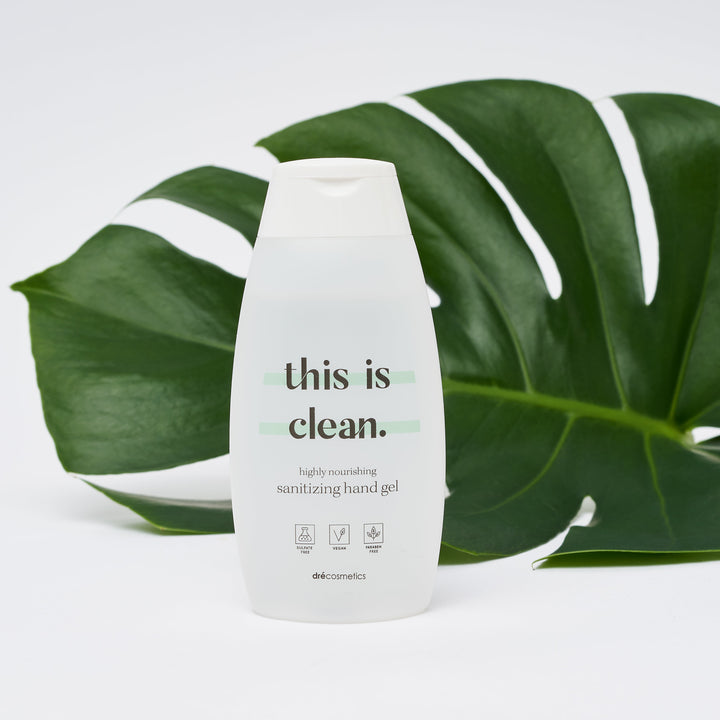 This is Clean hand gel bottle on a green leaf, promoting hydration and effective cleansing for healthy hands.
